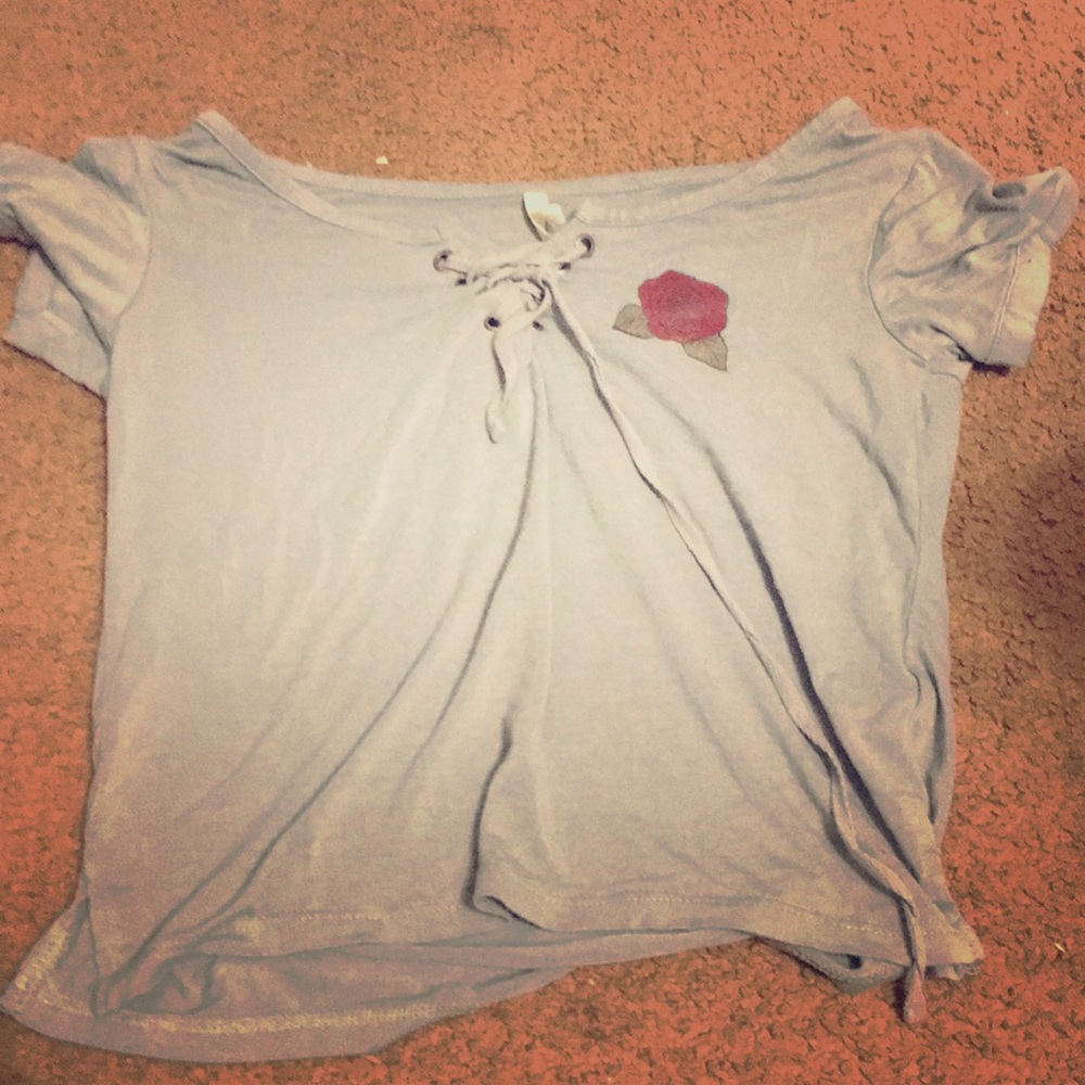 A blue crop top with a red rose